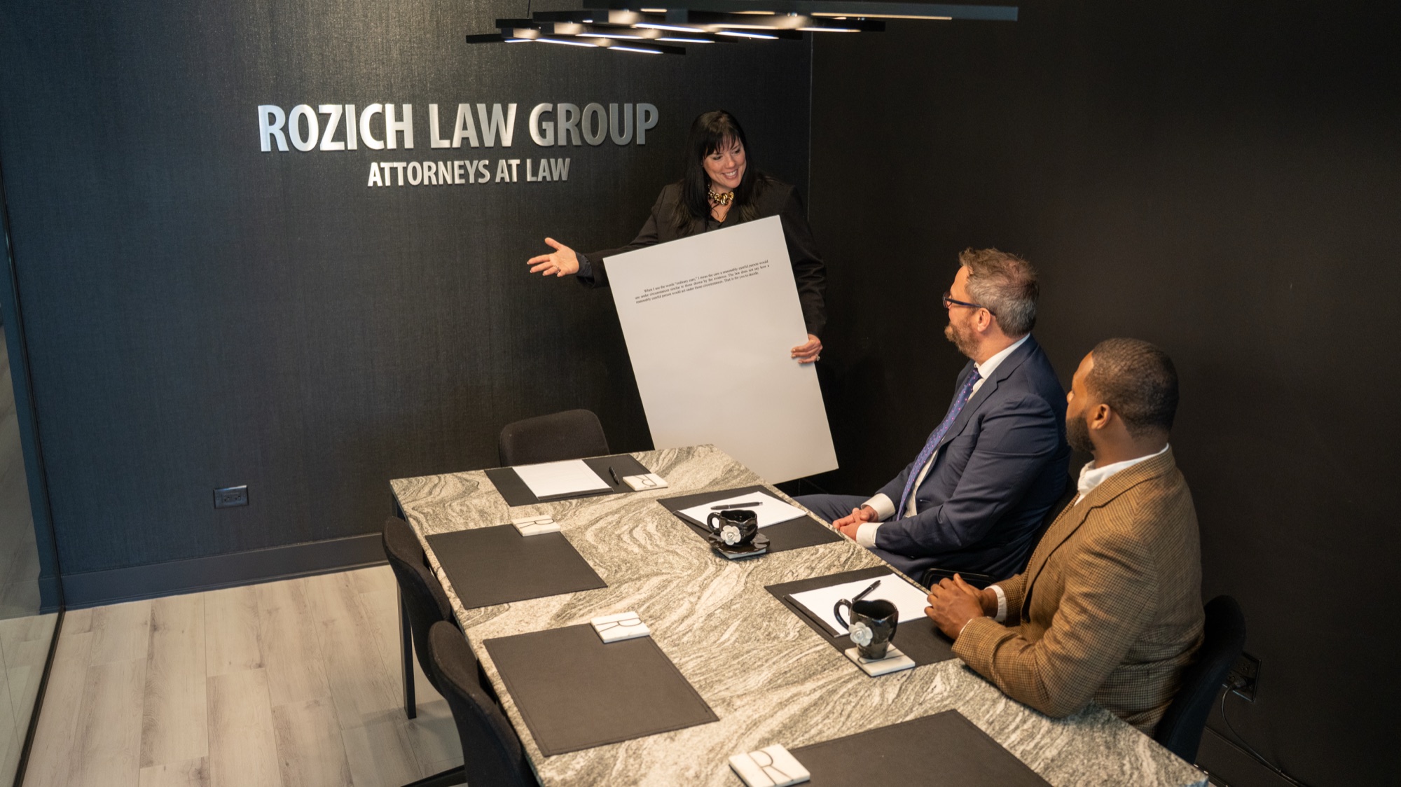 Lauren Rozich presenting at the conference table in the Rozich Law Group office